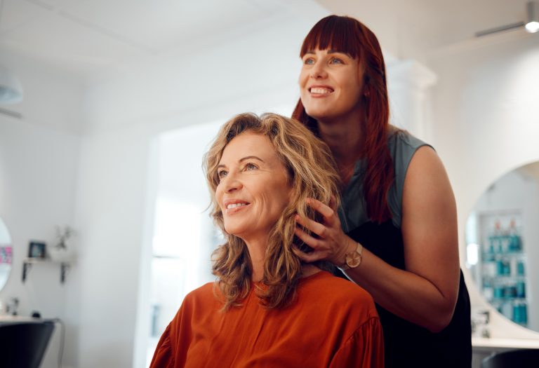 Hairdresser, senior woman client and hair care consultation with young hairstylist in training