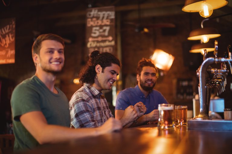 Group of male friends watching football match